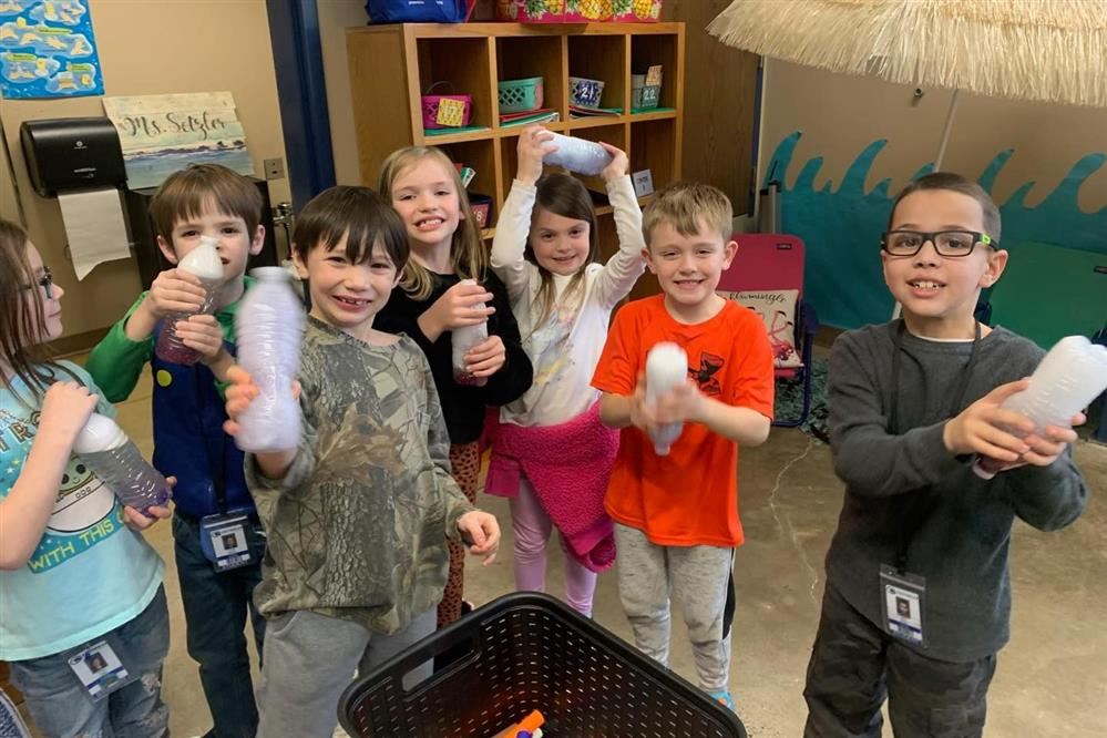  students showing off their cyclones during science